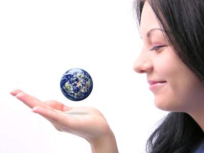 woman holding globe - distracted from her need for relationship or relationship hunger